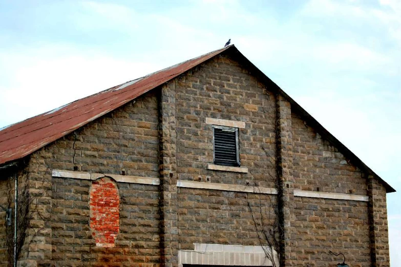 a red brick building with two windows and a large door