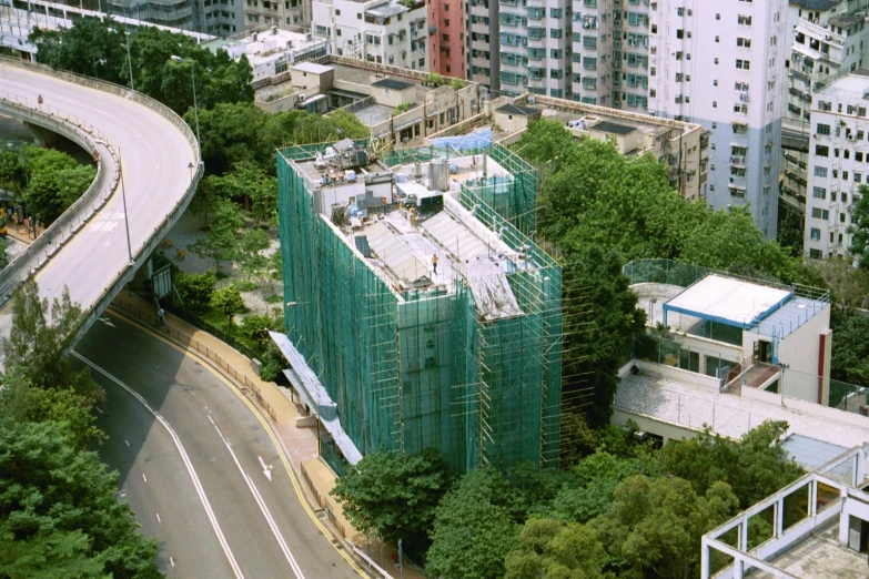 a building in a very tall city with large green scaffolding