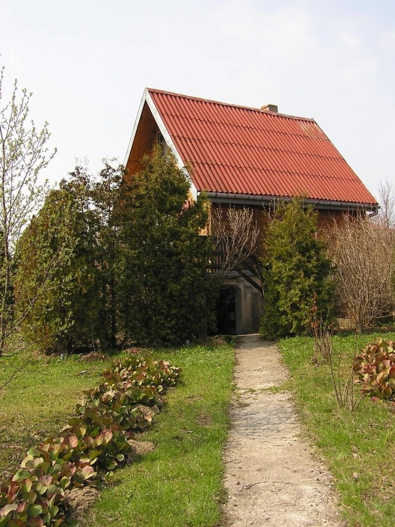 an old country house that has a red roof