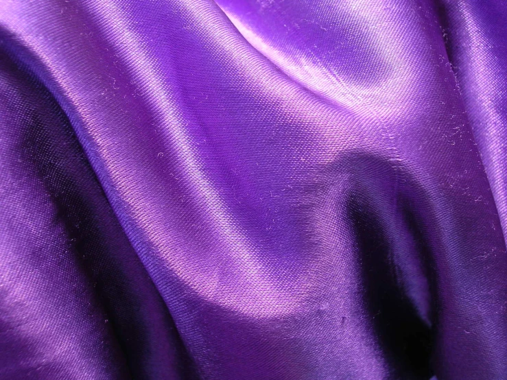 purple fabric with a slight ruffle and dark background