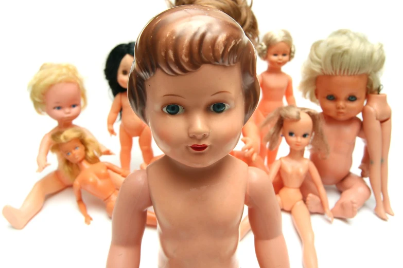 small dolls of various sizes sitting in a row