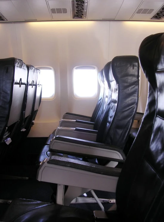 some seats in the aisle of a plane on a plane