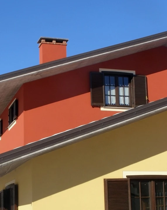 a red and yellow house with black shutters