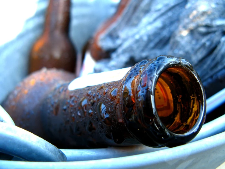 an old bottle that is sitting in a white bucket