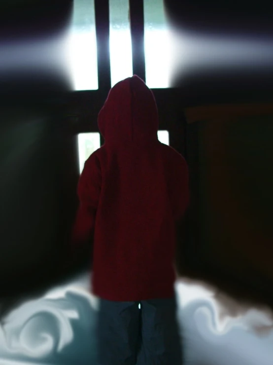 a person standing in front of the window with his coat open