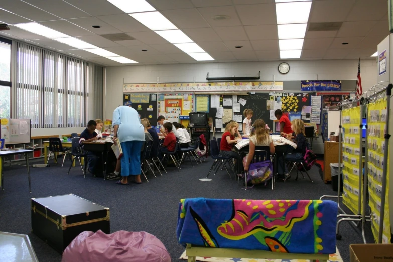 a classroom with desks and people sitting at their computers