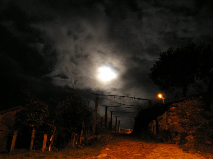 a dark sky is lit by the moon