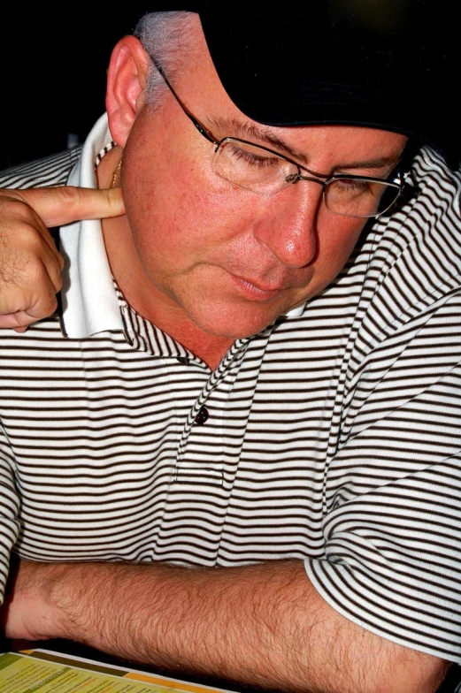 a man sitting at a table reading a book