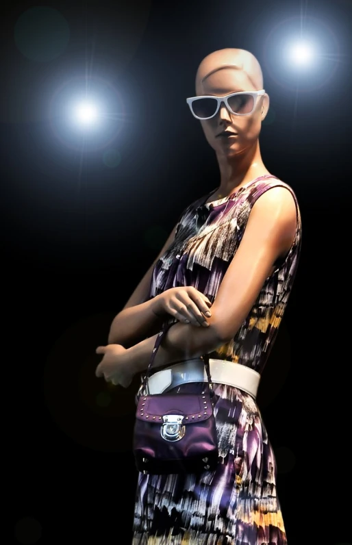 a woman's fashion model wearing sunglasses and a purse