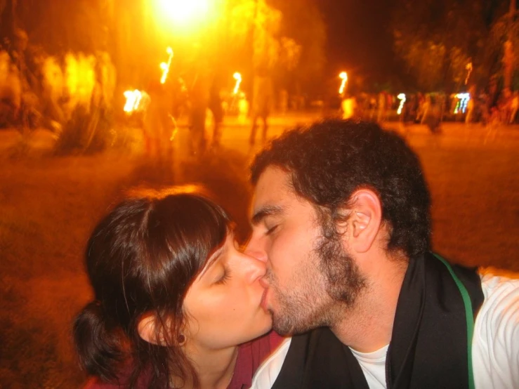 a man kissing the cheek of a beautiful woman