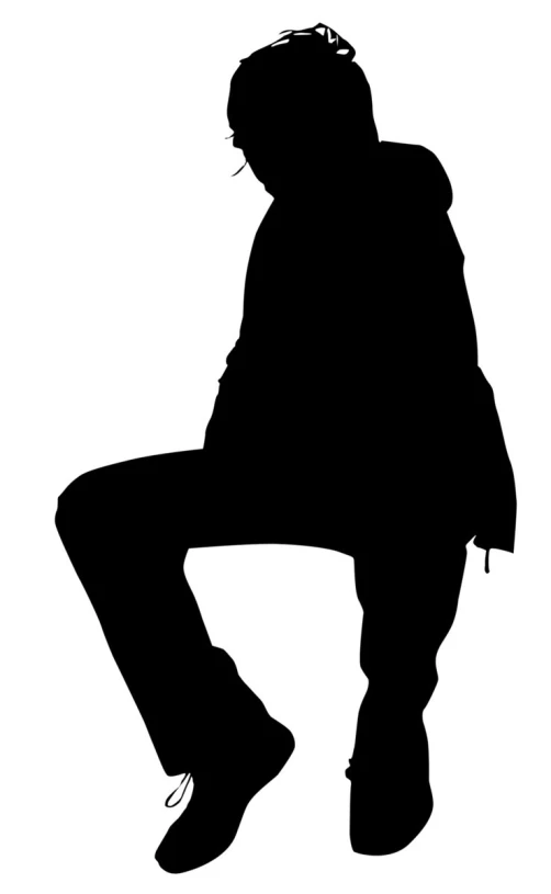 a silhouette of a man sitting on top of a skateboard