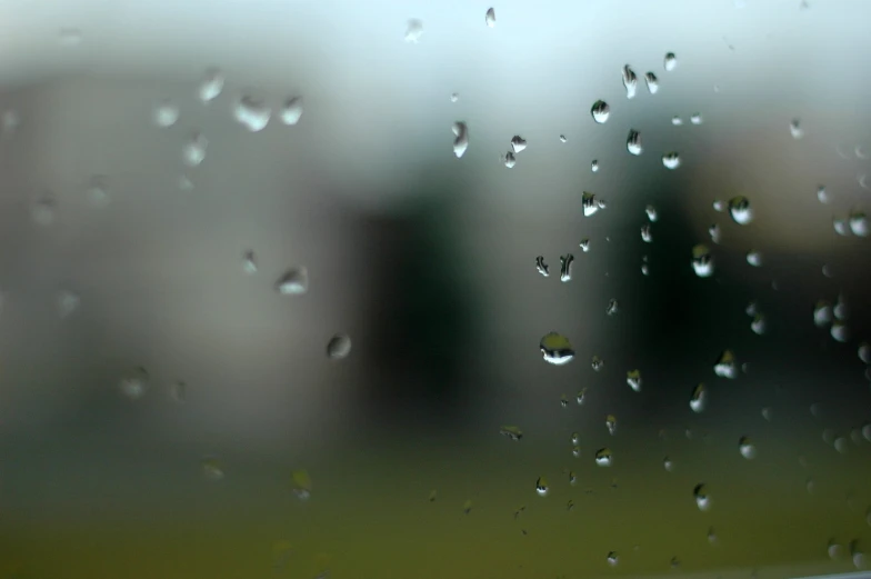 drops of rain are falling from the window