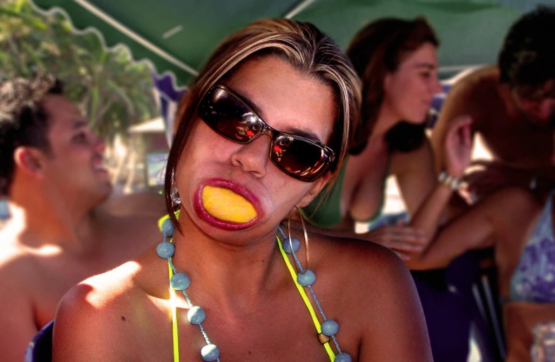 a woman with yellow candy pops out of her mouth