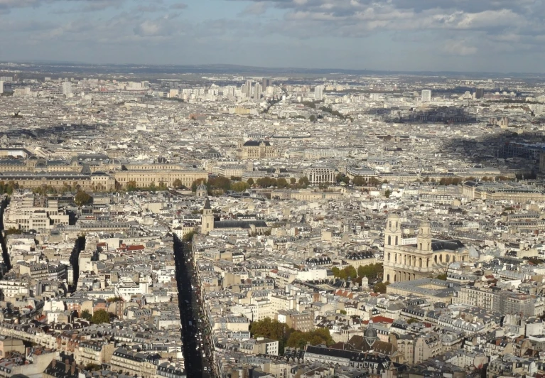 a large city has very tall buildings and clouds in the sky