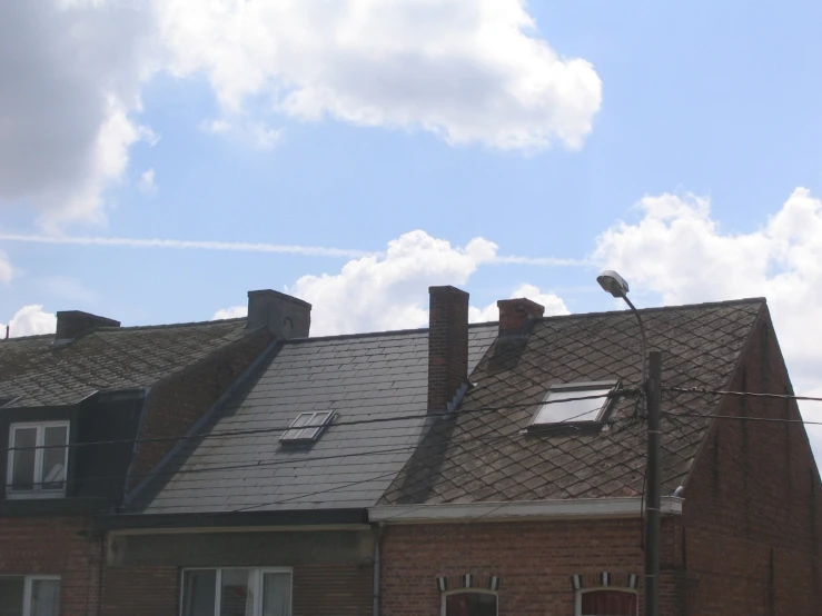 an old house with a bird sitting on the roof