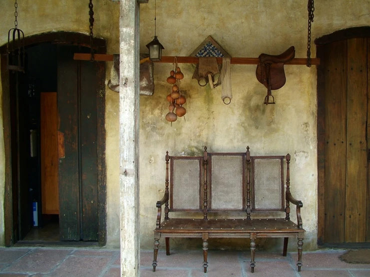 a house with three benches near the entry way