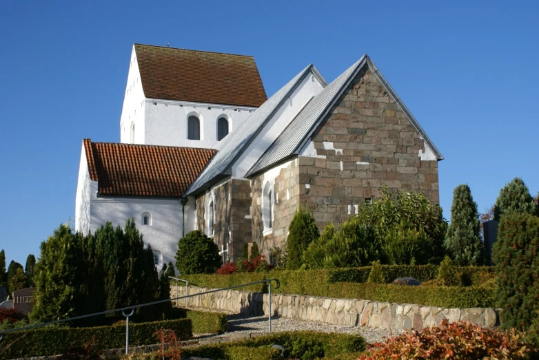 a church is built with several steeples and trees