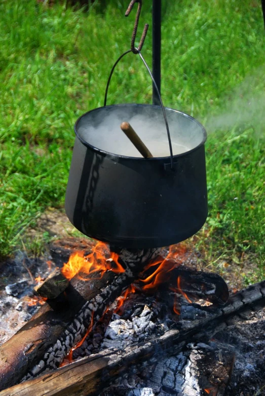 a grill on an open flame in the grass