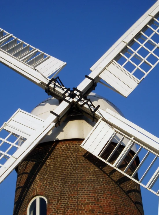 a large white windmill with windows in front of it