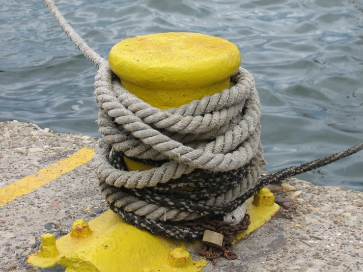 a round object is tied to a cement post