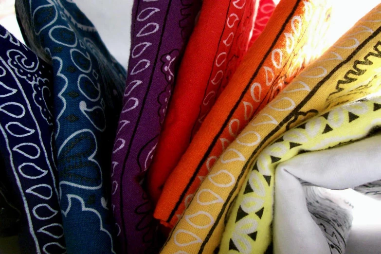 a pile of different colored and patterned cloths