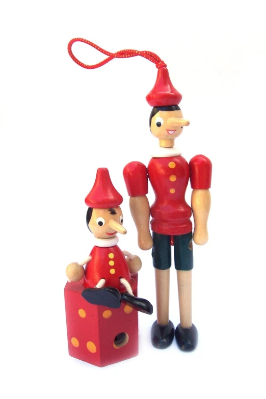 two plastic toy figures are standing next to each other