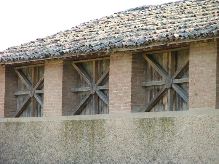 a building with four cross windows and a tiled roof