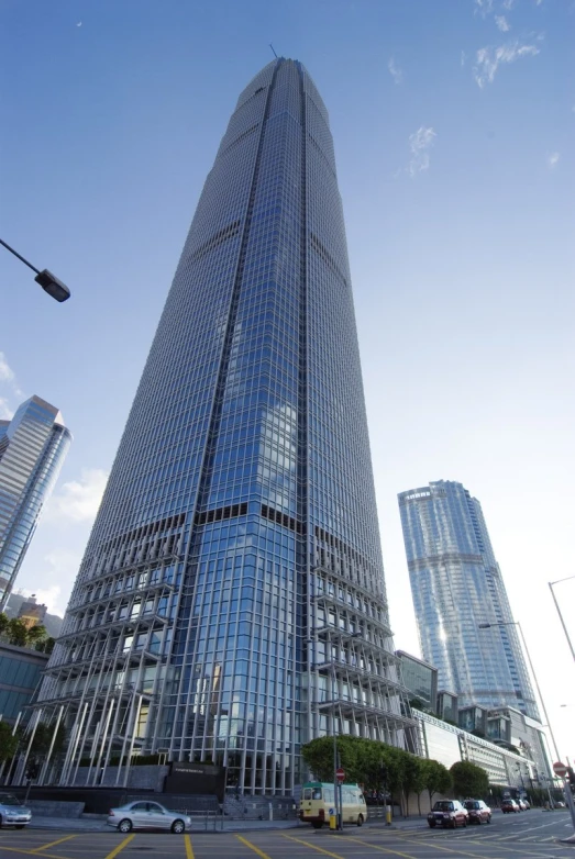 tall building with multiple windows and two parking spots