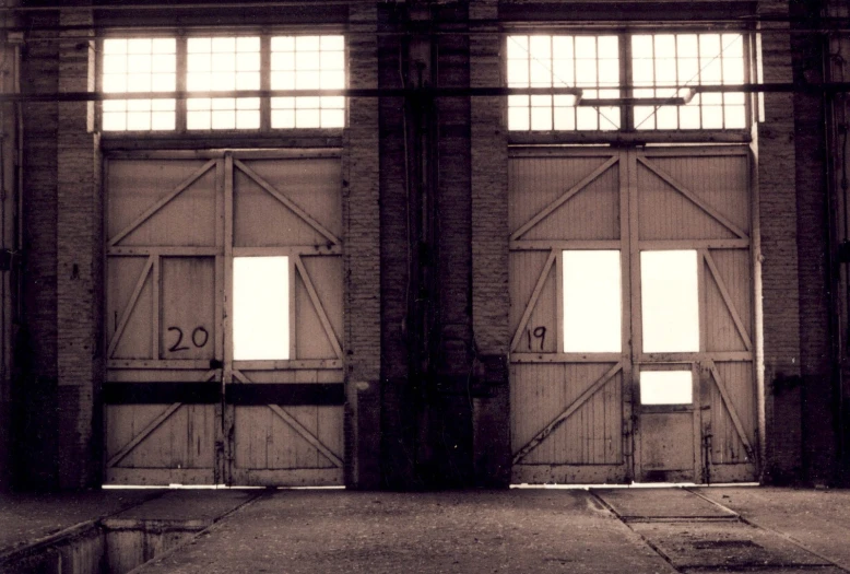 a couple of doors in a building with multiple windows