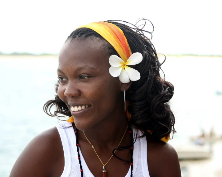 a woman smiling and wearing colorful hair accessories