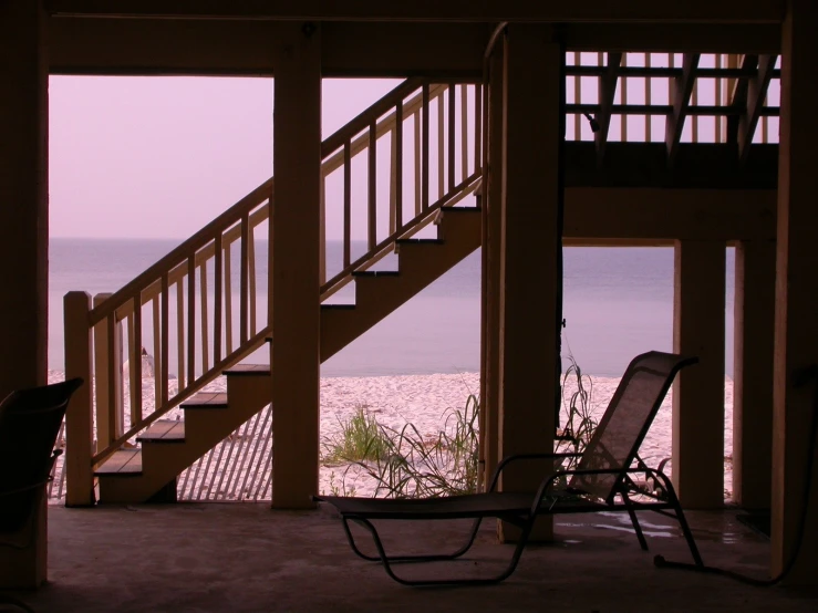 staircase leading to the beach and a deck chair under
