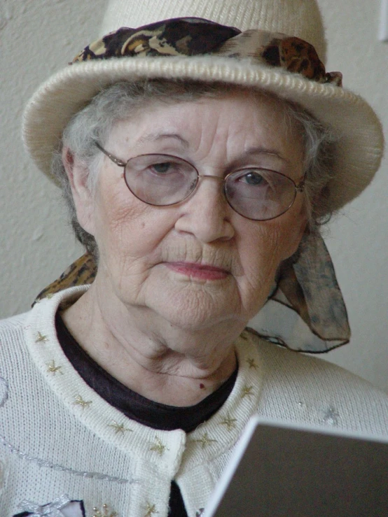 the older woman has glasses and a hat on