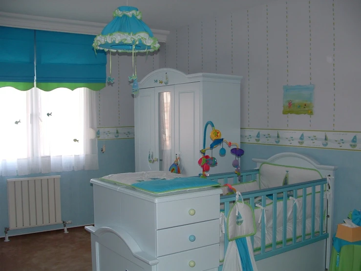 a baby crib has several drawers in the nursery