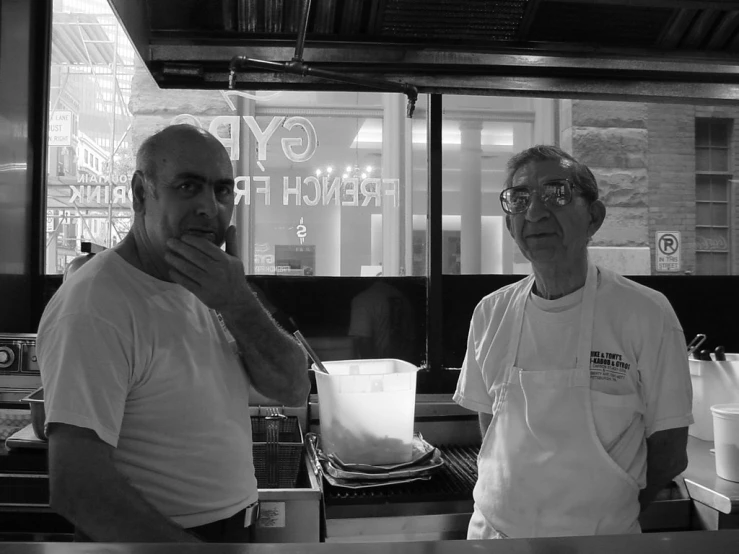 black and white image of two men in a restaurant kitchen