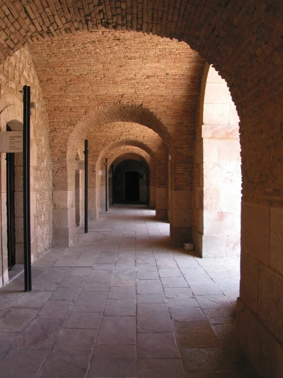 an arched brick passage between two buildings