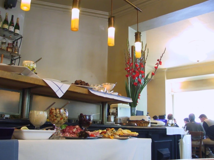 a buffet with food and beverages in front of a light