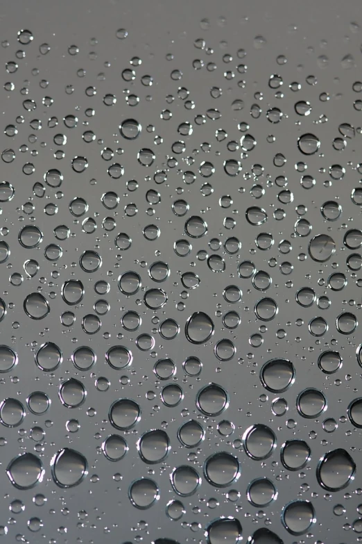 a close up of water droplets on a window pane