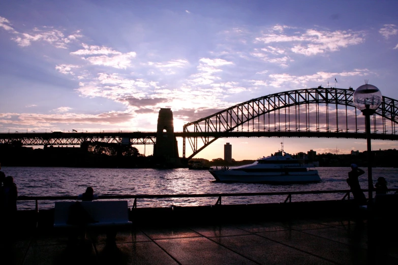 silhouettes of people and a boat on a body of water