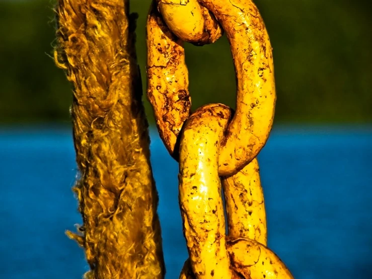 the yellow chain is hanging by a pole