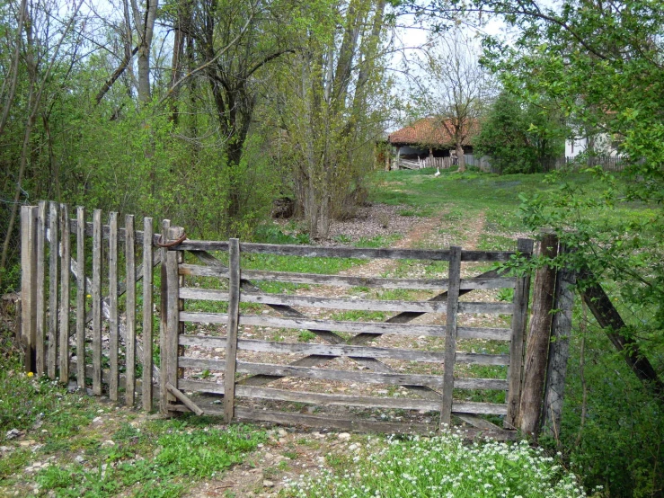 a large fence with a log design and wooden rails