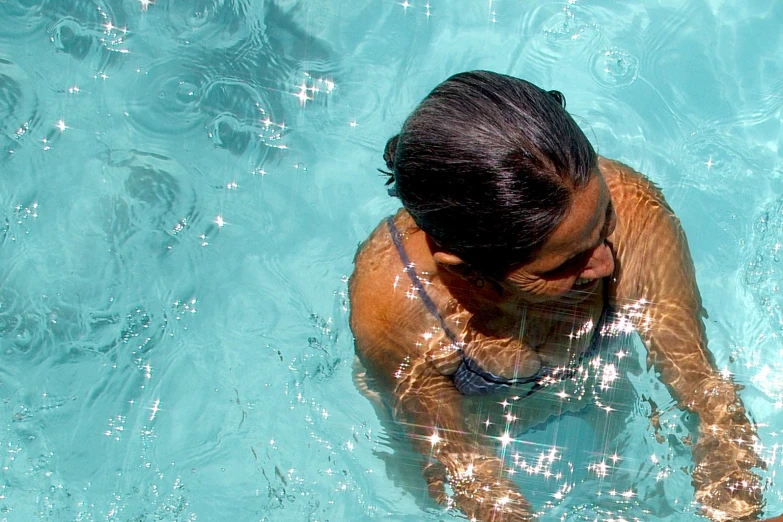 a women is in the water with her shirt on