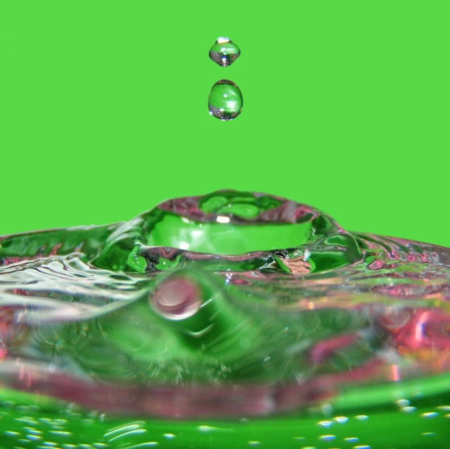 the water has been dropped in to a green bowl