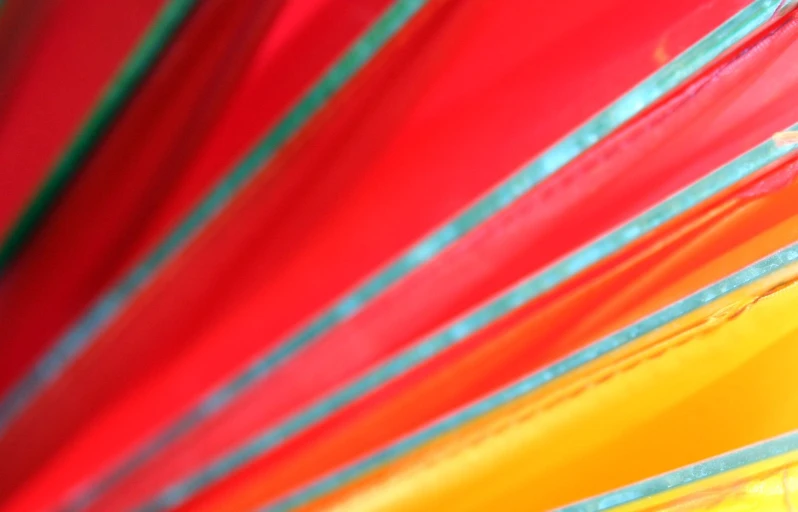 colorful umbrellas lined up and folded with blue lines on them