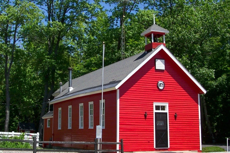 an old church surrounded by lots of trees