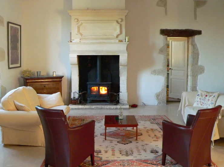 a white living room with a fire place next to a chair