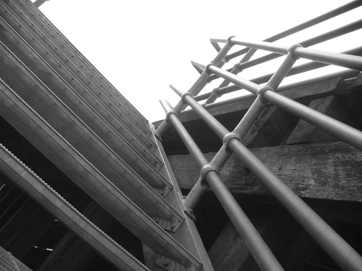 a black and white image of metal fencing