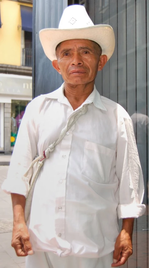 an older man in a white hat with  and pants