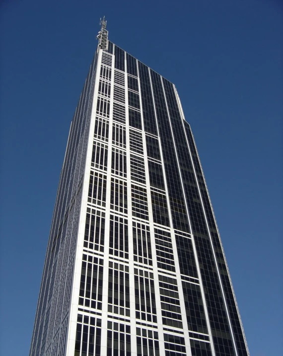 the sky is blue and a high rise building has many windows
