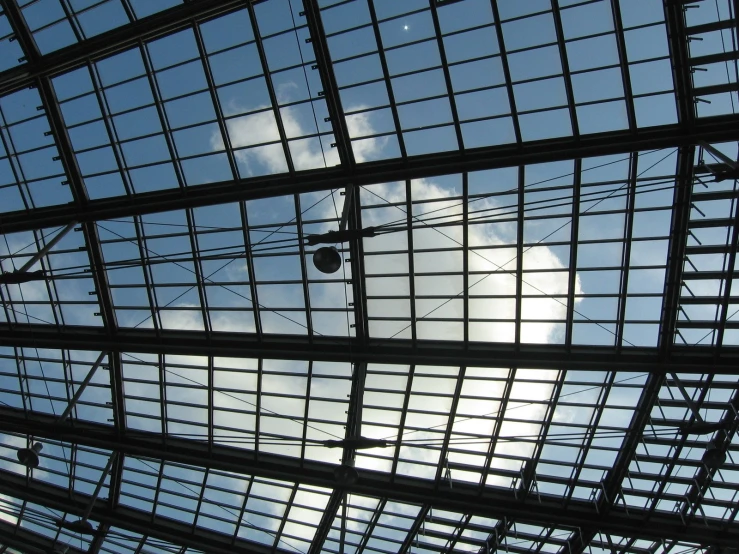 a window with a sky and clouds behind it