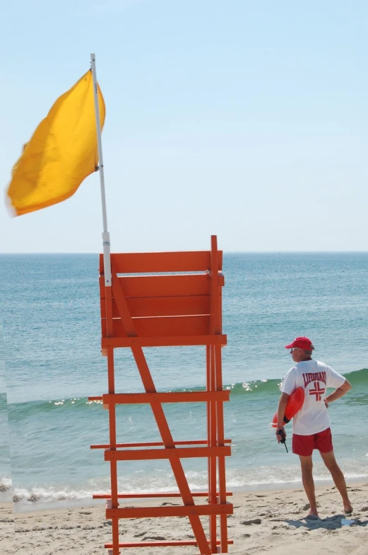 the life guard is watching the people out at the beach